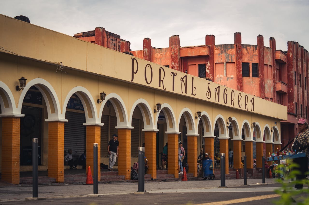 services-03 Colorful colonial-style arches at Portal Sagrera in San Salvador's bustling center capture vibrant city life.